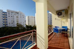 a balcony of a apartment with a table and chairs at Edificio Caique C in Armação de Pêra