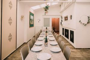 a long dining room with a long table and chairs at Zythogite, 23 personnes, 9 chambres, 6 salles de bain, bbq, jacuzzi, jardin, billard in Tintigny