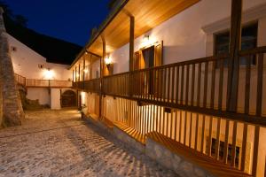 a building with a balcony with lights on it at Rooms & Apartments Podsreda Castle in Podsreda