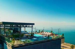 a swimming pool on top of a building with the water at Boulevardside in Batumi
