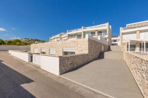 un gran edificio de ladrillo con una acera delante de él en Villa Punta Ristola by Perle di Puglia, en Leuca