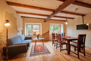 a living room with a blue couch and a table at Radler Pension Wettin in Wettin