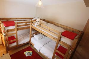 two bunk beds in a room with a teddy bear at Le Chalet in Peisey-Nancroix