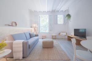 a living room with a blue couch and a tv at MARsuites Palma - Turismo de Interior TI 162 in Palma de Mallorca