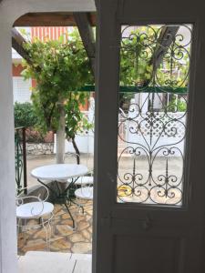 a door leading to a patio with a table and chairs at Vintage House for rent 60m from Sea in Baška Voda