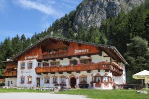 a building in front of a mountain at Bärenwirt in Leutasch