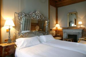 a hotel room with a large mirror and a bed at Hotel Castillo de Arteaga in Gautegiz Arteaga