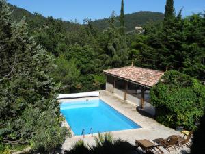 a swimming pool in front of a house at les chambres de Rocbaron in Rocbaron
