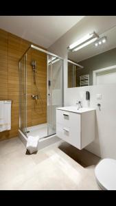 a bathroom with a shower and a toilet and a sink at Golf Apartament 10 in Wejherowo
