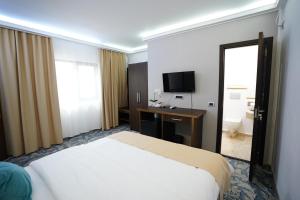 a hotel room with a bed and a television at Hotel AquaMarine in Costinesti +53 photos