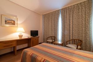 Postel nebo postele na pokoji v ubytování Hospedium Hotel Europa Centro