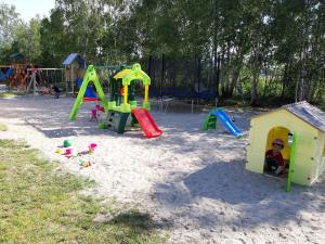 a group of playground equipment in the sand at Domki u Leona in Dąbki