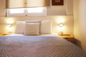 A bed or beds in a room at HABITAT Nafplio bnb - Design Apartment