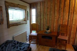 a room with wooden walls and a table and chairs at Kulppis Bed&Breakfast in Härryda