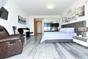 a hotel room with a bed and a couch at Exclusive Luxury Apartments in Oceano Atlantico Complex in Portimão