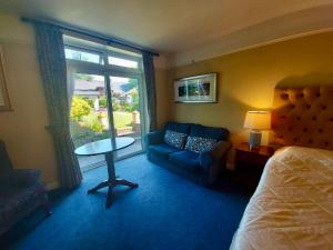 a hotel room with a bed and a couch and a table at Belvedere Lodge in Cork