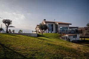 a house on top of a grassy hill at Ranieri Events and B&B in Casacanditella