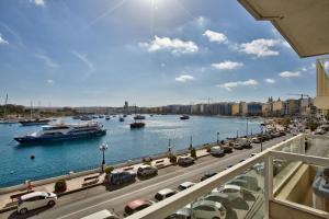 a view of a river with parked cars and boats at Exceptional Tigne Seafront Apartments by Shortletsmalta in Sliema