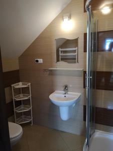 a bathroom with a sink and a toilet and a shower at Rivabell in Ostrowo +82 photos