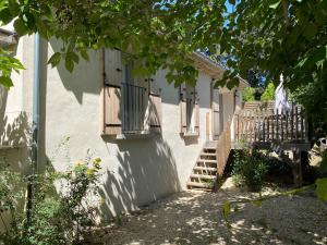 a white building with some balconies on the side of it at Fanchon des Sablons in Sarrians