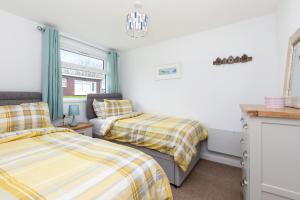 a bedroom with two beds and a window at 40 Norton Park in Dartmouth