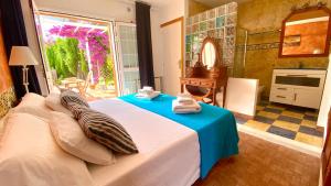 a bedroom with a bed with towels on it at CAN DAMIA 2 in Cala Saona