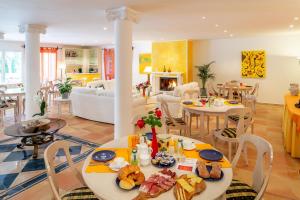 a living room with two tables with food on them at Hotel al Ponte Antico in Intragna