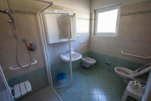 a bathroom with a shower and a sink and a toilet at Casa per Ferie Le Rais in Pozza di Fassa +31 photos