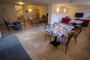 a dining room with tables and chairs and a tv at Casa per Ferie Le Rais in Pozza di Fassa