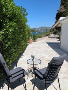 two chairs and a table on a patio at House Damić in Korčula