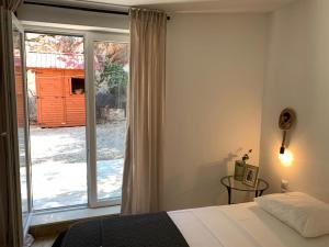 a bedroom with a bed and a large window at House Damić in Korčula