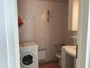a bathroom with a washing machine and a toilet at Sun&Sea Terrace Two-Bedroom Apartment in Roquebrune-Cap-Martin