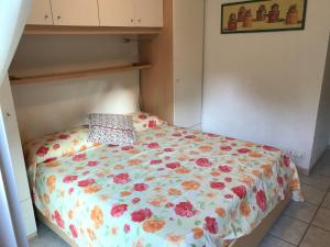 a bed with a floral comforter in a bedroom at Sun&Sea Terrace Two-Bedroom Apartment in Roquebrune-Cap-Martin