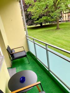 a balcony with a table and a view of a park at Apartment Celin in Hannover