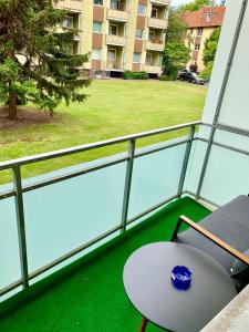 a balcony with a table and a view of a building at Apartment Celin in Hannover