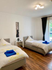 a bedroom with two beds with blue towels on them at Apartment Celin in Hannover
