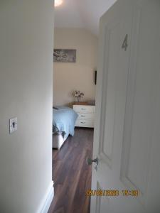 an open door to a bedroom with a bed at THE LODGE (Belmullet town centre) in Belmullet