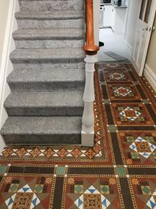 a staircase with a mosaic floor and a stair case with a tile floor at THE LODGE (Belmullet town centre) in Belmullet