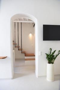 a room with a staircase leading to a hallway at Blanco Rooms Mykonos in Mýkonos City