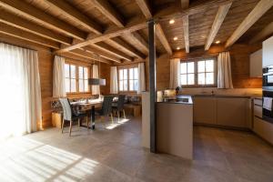 a kitchen and dining room with a table and chairs at Chalet Frümsel in Wildhaus