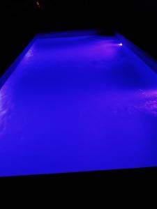 a swimming pool with blue lights on top of it at Casa da Eira in Reguengos de Monsaraz