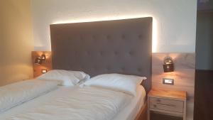 Postel nebo postele na pokoji v ubytování Aparthotel Malga