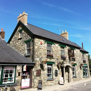 an old stone building on the side of a street at Castle Inn in Newport Pembrokeshire