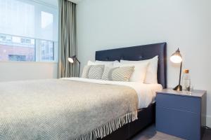 a bedroom with a large bed and a window at Native Tower Bridge in London