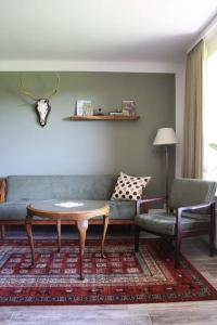 a living room with a couch and a coffee table at Landhaus Tipp in Altenmedingen