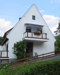 a white house with a balcony at Gottschlich Apartment Schmallenberg in Schmallenberg