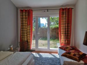 a bedroom with a large window with red curtains at Cassis Hostel in Cassis