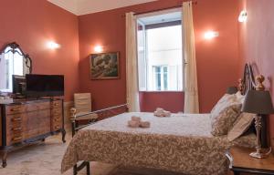 a bedroom with a bed with a television and a window at Antica Terrazza Frascati in Frascati