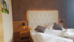 Postel nebo postele na pokoji v ubytování Aparthotel Malga + 37 fotografií