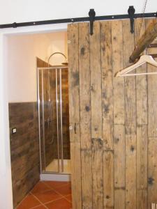 a sliding barn door in a bathroom with a shower at Casolare Casa Ricci in Riotorto